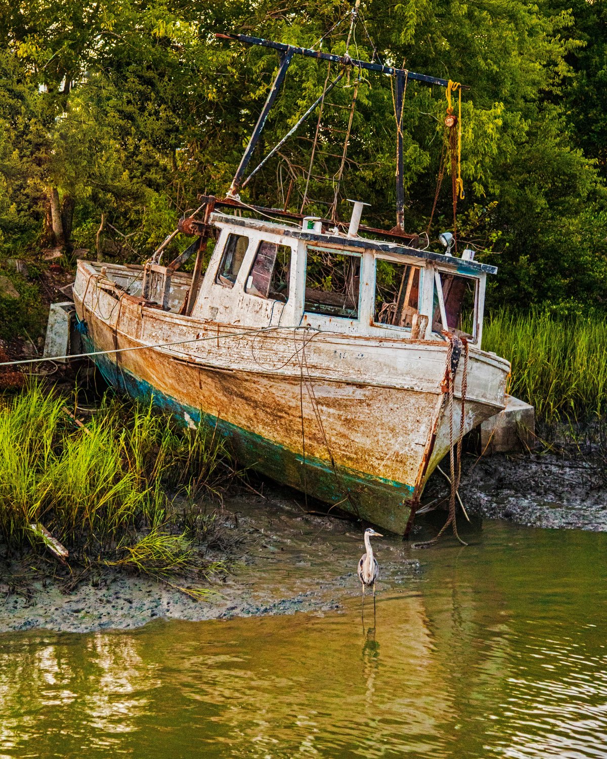 A fishing boat is beached along the San Sebastian River in St. Augustine. See the poem for this photo by Dean Strecker in the breakout box.